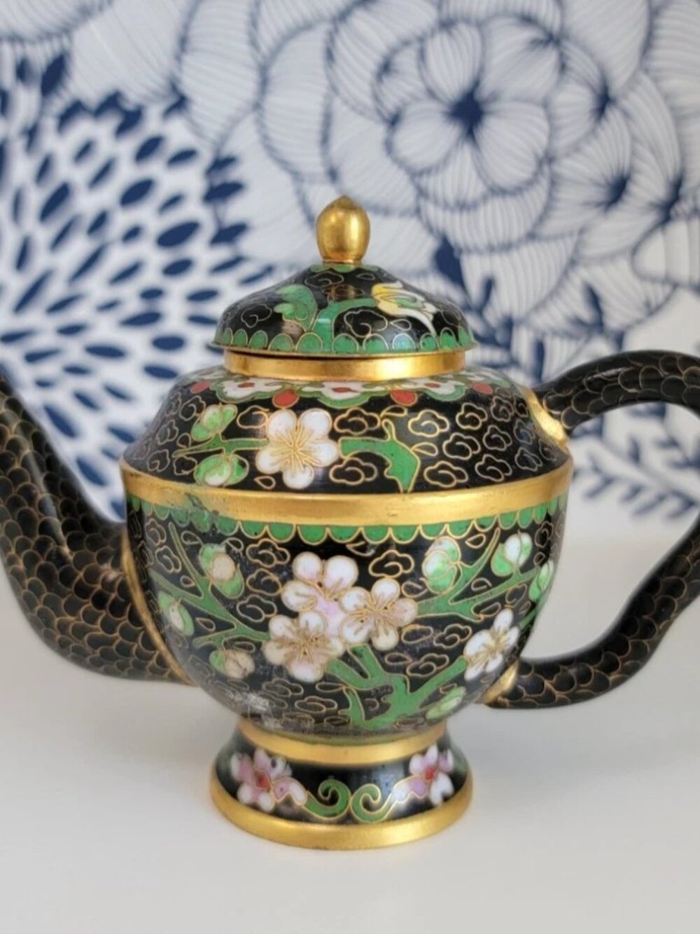 Miniature cloisonne teapot, black with gold, green stems, white flowers GUC